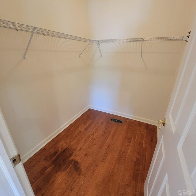 spacious closet featuring hardwood / wood-style floors