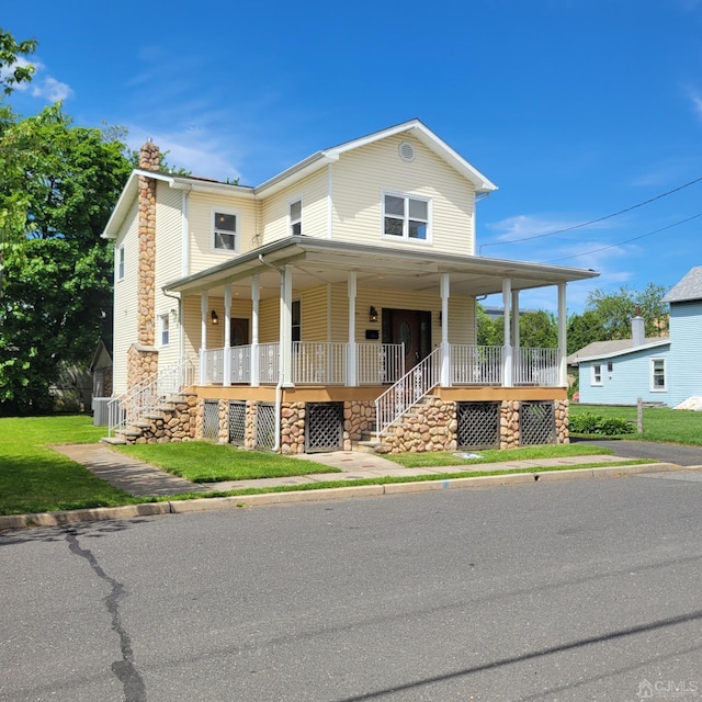 country-style home featuring a front lawn and a porch