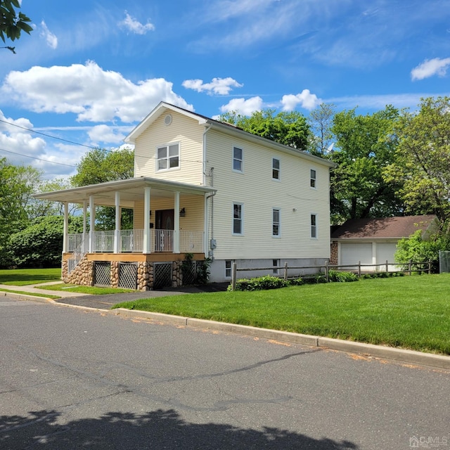 view of front of house with covered porch and a front lawn