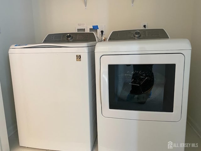 washroom featuring laundry area and washer and dryer