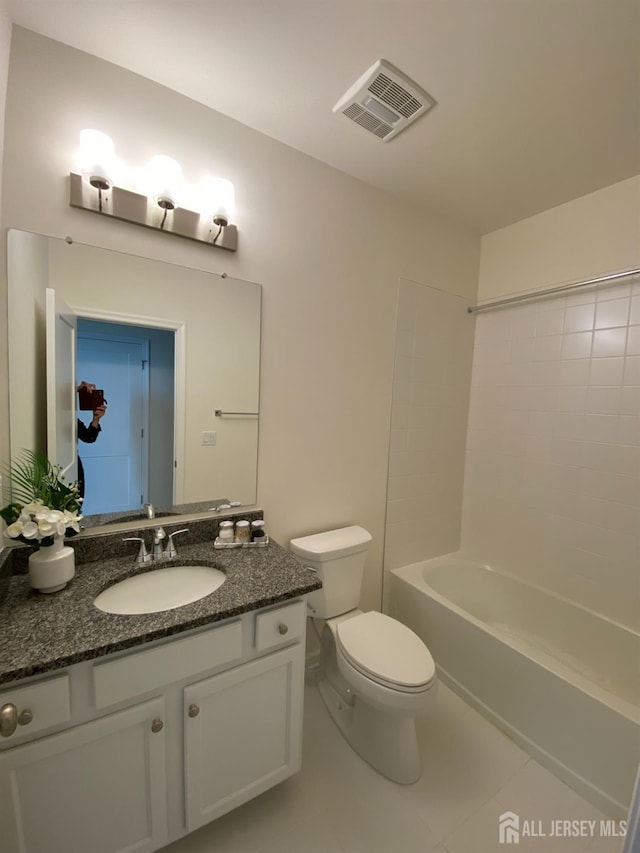 bathroom featuring tile patterned floors, visible vents, toilet, bathtub / shower combination, and vanity