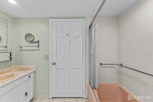 bathroom featuring tile patterned flooring, vanity, and bathing tub / shower combination