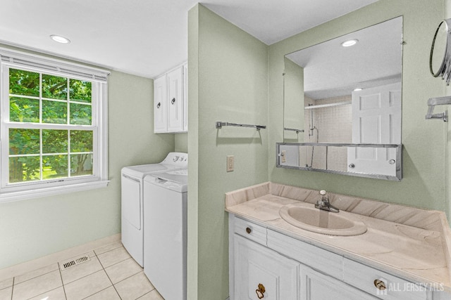 bathroom with tile patterned flooring, vanity, separate washer and dryer, and a shower with shower door