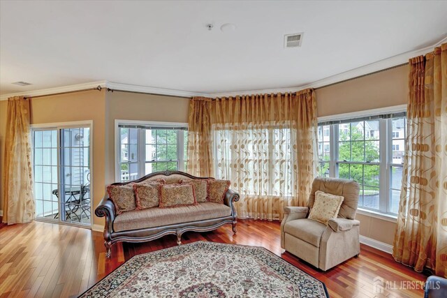 4215 Falston Cir Unit 15, Old Bridge, NJ 08857 - living area featuring plenty of natural light, wood finished floors, and ornamental molding