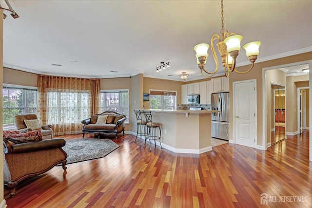 4215 Falston Cir Unit 15, Old Bridge, NJ 08857 - kitchen featuring appliances with stainless steel finishes, open floor plan, white cabinets, a chandelier, and healthy amount of natural light