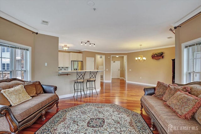 4215 Falston Cir Unit 15, Old Bridge, NJ 08857 - living area featuring a chandelier, light wood-style flooring, and crown molding