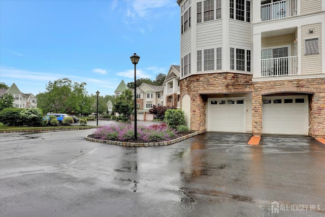 4215 Falston Cir Unit 15, Old Bridge, NJ 08857 - view of building exterior with an attached garage, driveway, and a residential view