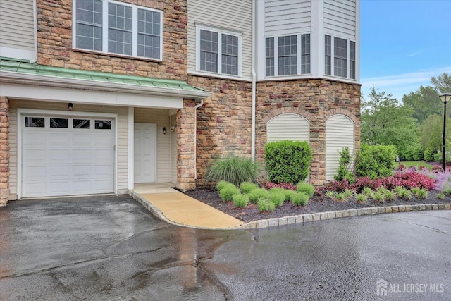 4215 Falston Cir Unit 15, Old Bridge, NJ 08857 - doorway to property featuring stone siding, a garage, and driveway