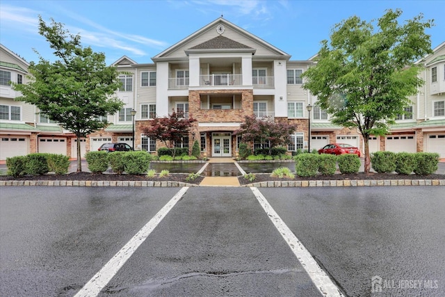 4215 Falston Cir Unit 15, Old Bridge, NJ 08857 - view of front of home featuring french doors, uncovered parking, and stone siding