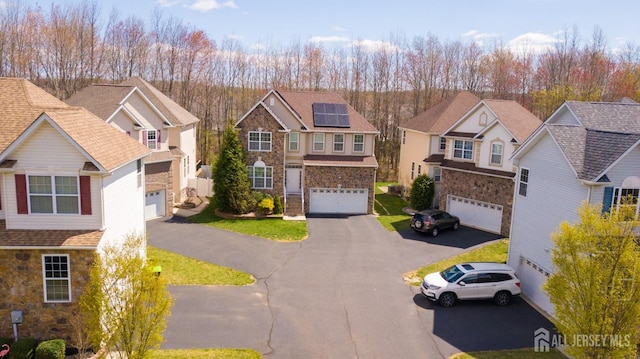 460 Morning Glory Dr, Monroe, NJ 08831 - view of front facade featuring stone siding, a residential view, asphalt driveway, and an attached garage