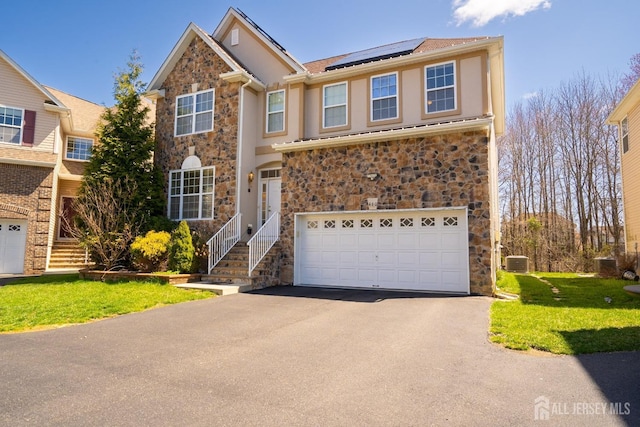 460 Morning Glory Dr, Monroe, NJ 08831 - traditional-style home featuring stone siding, a garage, driveway, solar panels, and a front yard