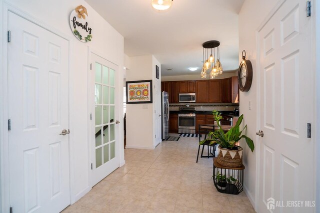 460 Morning Glory Dr, Monroe, NJ 08831 - hall with a chandelier, baseboards, and light tile patterned floors