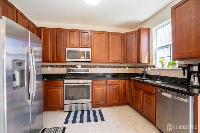 460 Morning Glory Dr, Monroe, NJ 08831 - kitchen featuring stainless steel appliances, a sink, backsplash, and brown cabinetry
