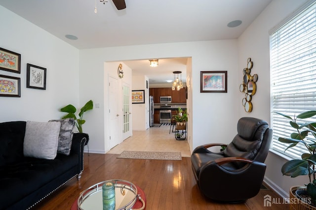460 Morning Glory Dr, Monroe, NJ 08831 - living area with healthy amount of natural light, light wood-style flooring, a ceiling fan, and baseboards