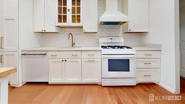 496 Calvert Rd, North Brunswick, NJ 08902 - kitchen with custom range hood, white appliances, a sink, white cabinetry, and light countertops
