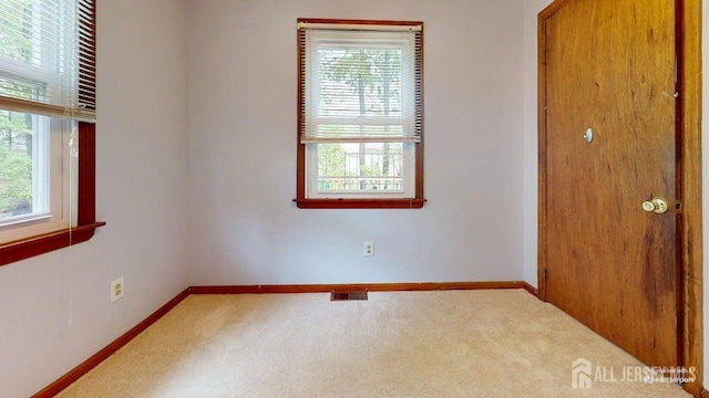 496 Calvert Rd, North Brunswick, NJ 08902 - carpeted empty room featuring healthy amount of natural light and baseboards