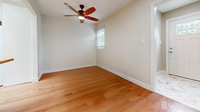 496 Calvert Rd, North Brunswick, NJ 08902 - foyer featuring healthy amount of natural light, light wood finished floors, a ceiling fan, and baseboards