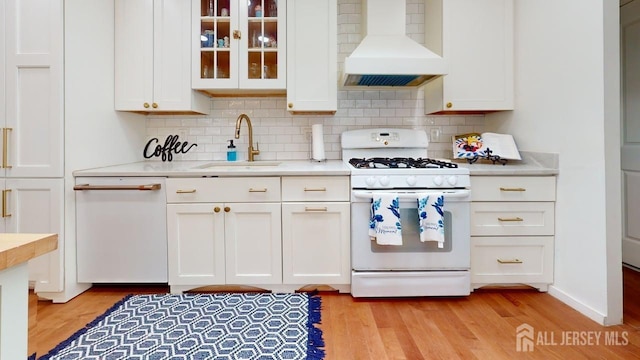 496 Calvert Rd, North Brunswick, NJ 08902 - kitchen featuring white appliances, custom range hood, a sink, white cabinets, and light countertops