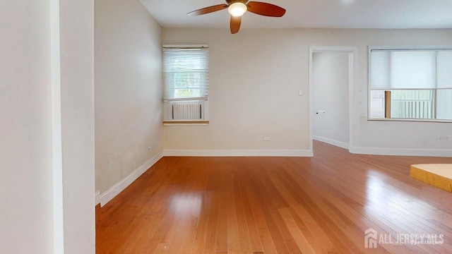 496 Calvert Rd, North Brunswick, NJ 08902 - spare room with wood-type flooring, ceiling fan, and baseboards