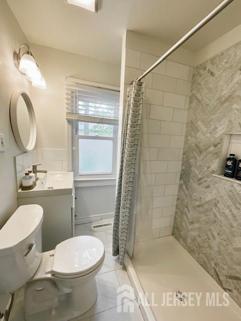496 Calvert Rd, North Brunswick, NJ 08902 - bathroom with toilet, a shower stall, tile patterned flooring, and vanity