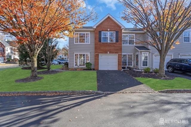 view of front of house featuring a front lawn and a garage