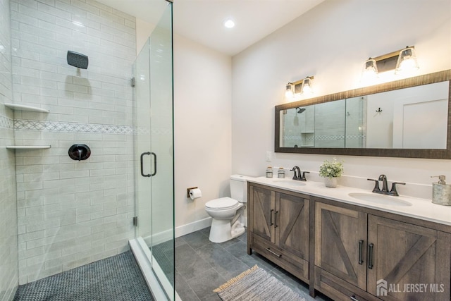 bathroom featuring tile patterned flooring, vanity, toilet, and walk in shower