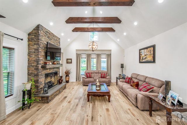 living room with light wood-type flooring, high vaulted ceiling, beamed ceiling, a fireplace, and a chandelier