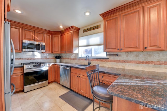 117 Whitman St, Carteret, NJ 07008 - kitchen with dark stone counters, brown cabinets, tasteful backsplash, a sink, and appliances with stainless steel finishes
