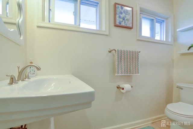 117 Whitman St, Carteret, NJ 07008 - half bathroom with baseboards, toilet, and a sink