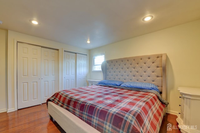 117 Whitman St, Carteret, NJ 07008 - bedroom with baseboards, recessed lighting, wood finished floors, and two closets