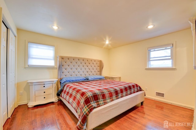 117 Whitman St, Carteret, NJ 07008 - bedroom with visible vents, a closet, baseboards, recessed lighting, and wood finished floors