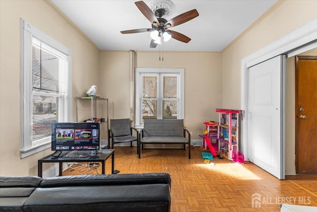 interior space with baseboards and a ceiling fan