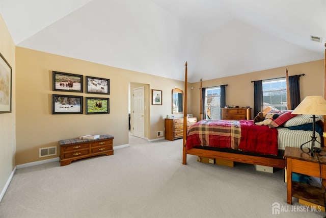 bedroom with lofted ceiling and light carpet