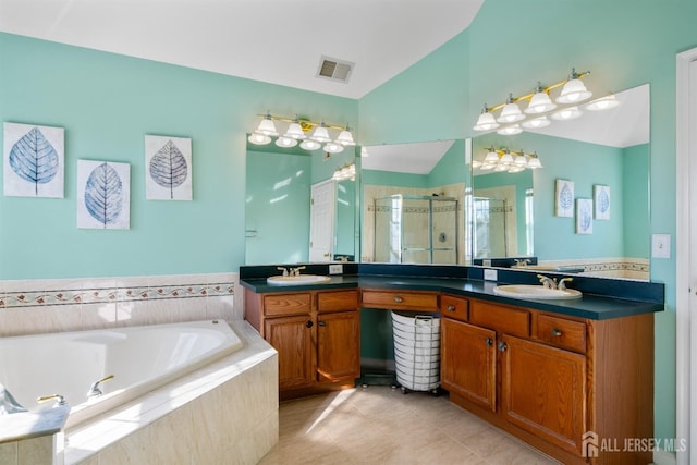 bathroom featuring vanity, vaulted ceiling, tile patterned floors, and plus walk in shower