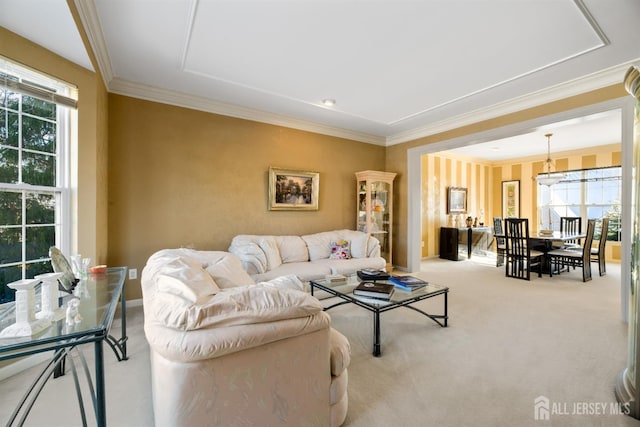 living room with crown molding, light colored carpet, and a healthy amount of sunlight