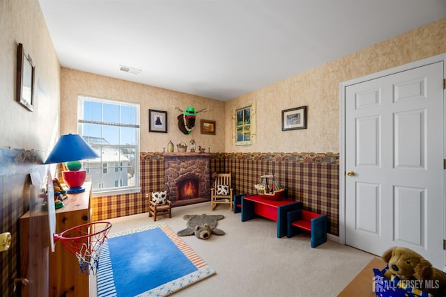 living area featuring a fireplace and carpet floors