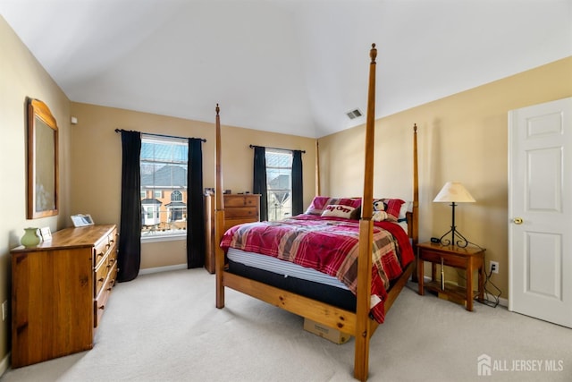 carpeted bedroom with lofted ceiling