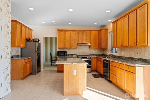 kitchen with sink, light tile patterned floors, a center island, black appliances, and light stone countertops