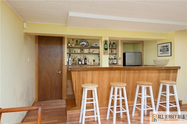 120 Alfred St, Edison, NJ 08820 - indoor dry bar with freestanding refrigerator, wood finished floors, and built in shelves