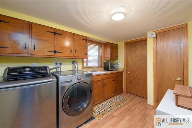120 Alfred St, Edison, NJ 08820 - laundry area featuring cabinet space, washer and dryer, and light wood-type flooring