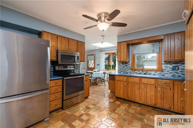 120 Alfred St, Edison, NJ 08820 - kitchen featuring appliances with stainless steel finishes, brown cabinetry, dark countertops, decorative backsplash, and ceiling fan