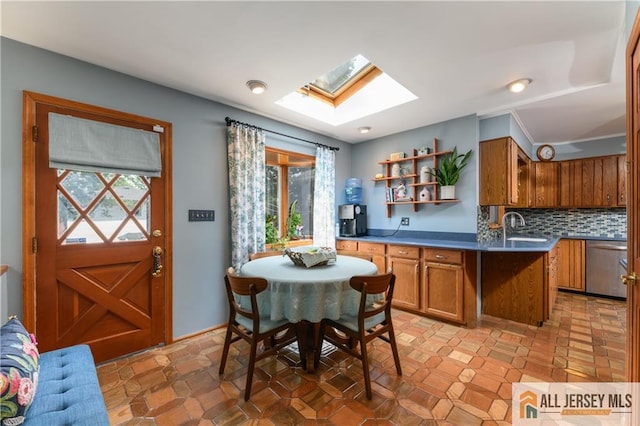120 Alfred St, Edison, NJ 08820 - kitchen with a skylight, stainless steel dishwasher, brown cabinets, open shelves, and tasteful backsplash