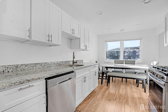 529 Sharon Garden Ct, Woodbridge Proper, NJ 07095 - kitchen featuring stainless steel appliances, light wood-type flooring, white cabinetry, light stone counters, and recessed lighting