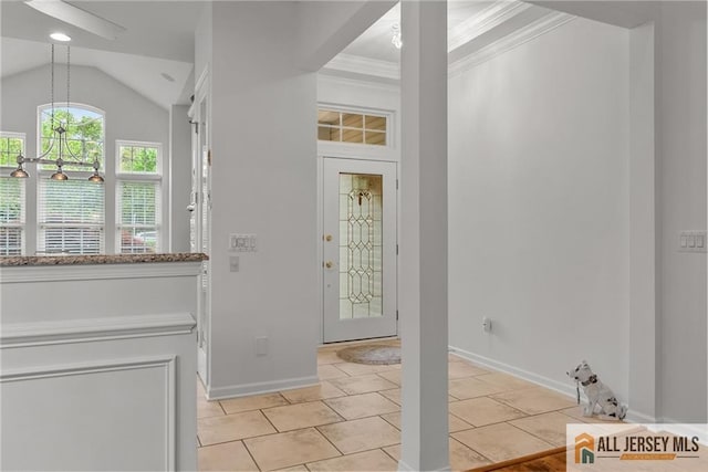 entrance foyer featuring crown molding, baseboards, light tile patterned floors, and vaulted ceiling