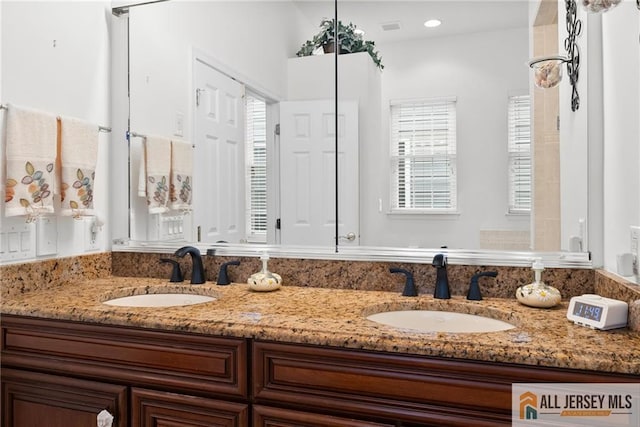 full bathroom featuring double vanity