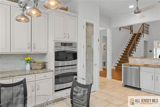 103 Einstein Way E, Windsor, NJ 08512 - kitchen with stainless steel appliances, white cabinetry, backsplash, and a sink
