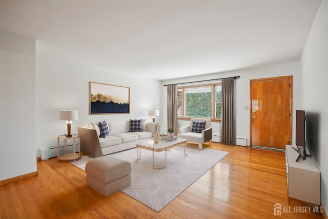 living room featuring a baseboard heating unit and light wood-type flooring