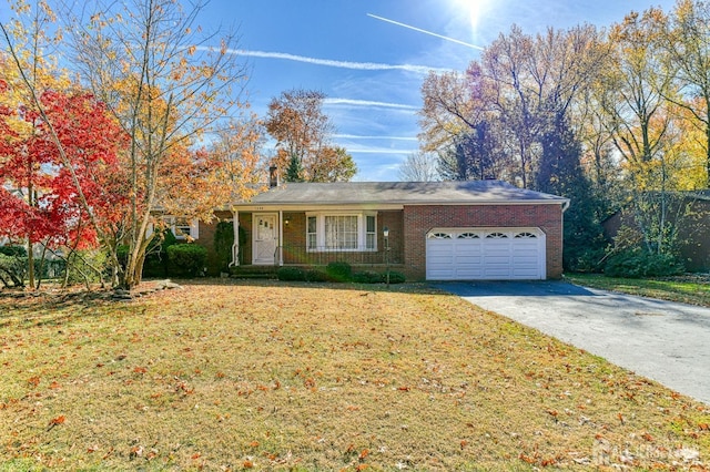 ranch-style house with a garage, covered porch, and a front lawn