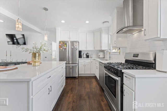 kitchen with white cabinets, stainless steel appliances, decorative backsplash, and wall chimney exhaust hood