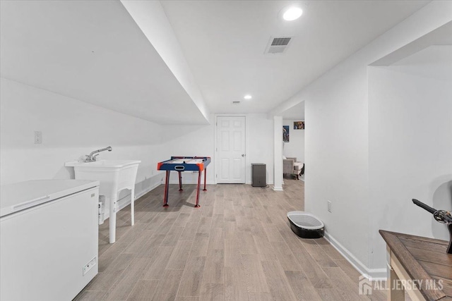 game room with visible vents, baseboards, light wood-style floors, recessed lighting, and a sink